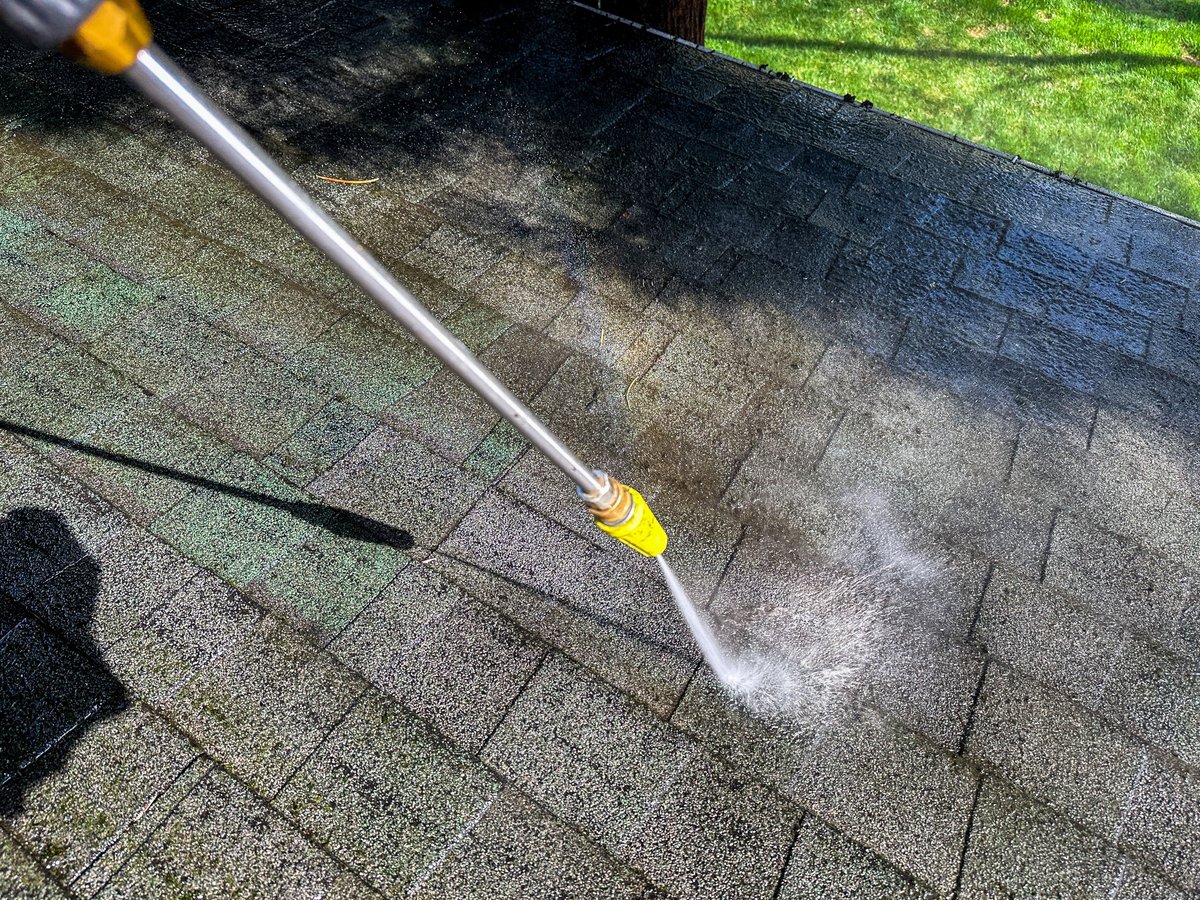 Pressure washing a residential roof