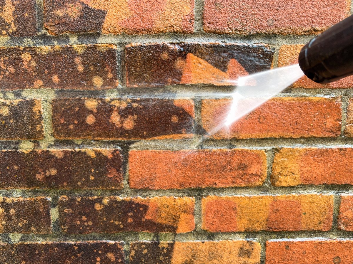 Pressure washing the exterior brick and siding of a home in Rolesville NC