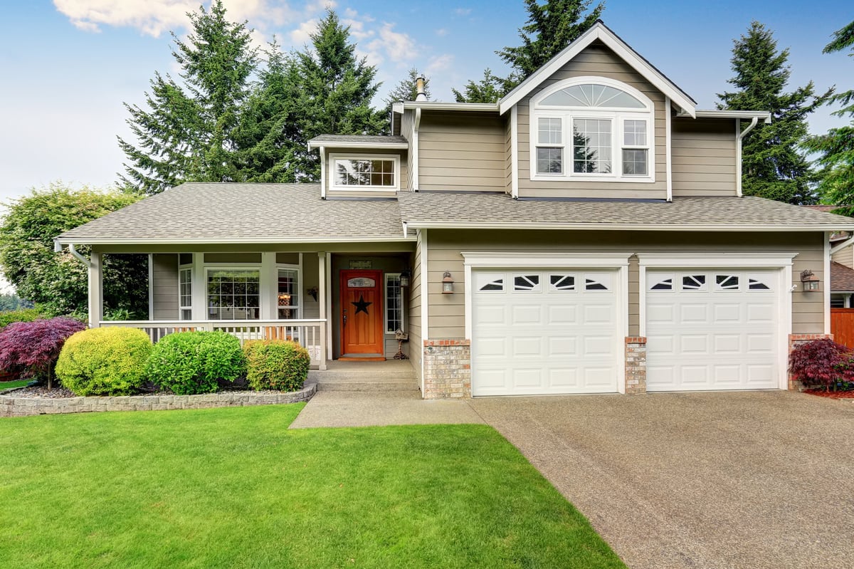 Curb appeal. American house exterior with double garage, concrete floor porch and well kept lawn. Northwest, USA