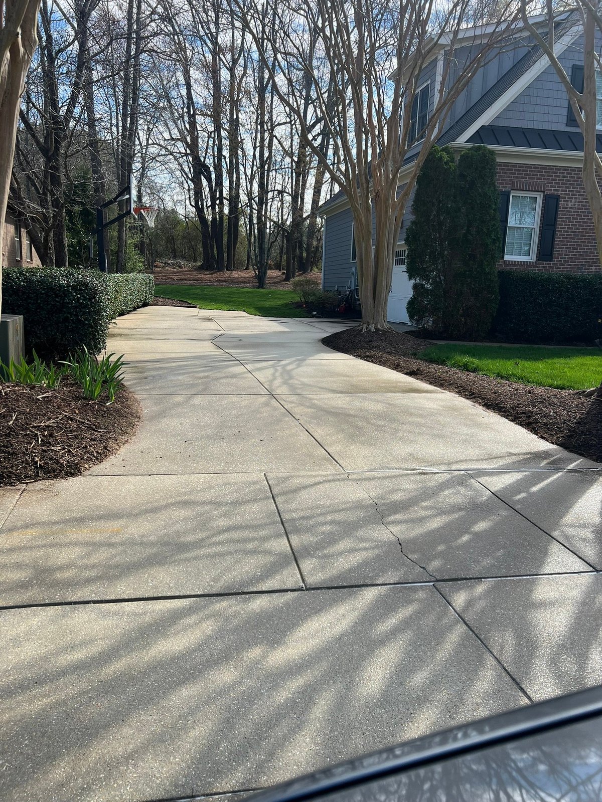 Bright clean concrete driveway at the same Wake Forest NC home after professional driveway cleaning