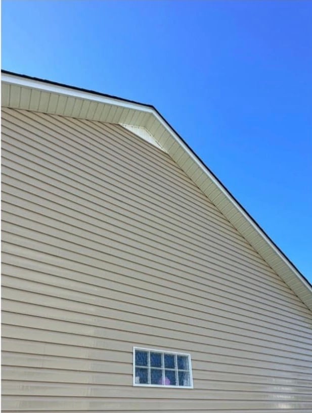 Heavy mold and mildew growth on tan vinyl siding of a Wake Forest NC home before soft washing