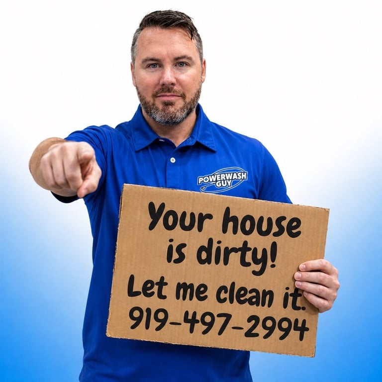 Powerwash Guy owner Mike pointing at the camera holding a cardboard sign