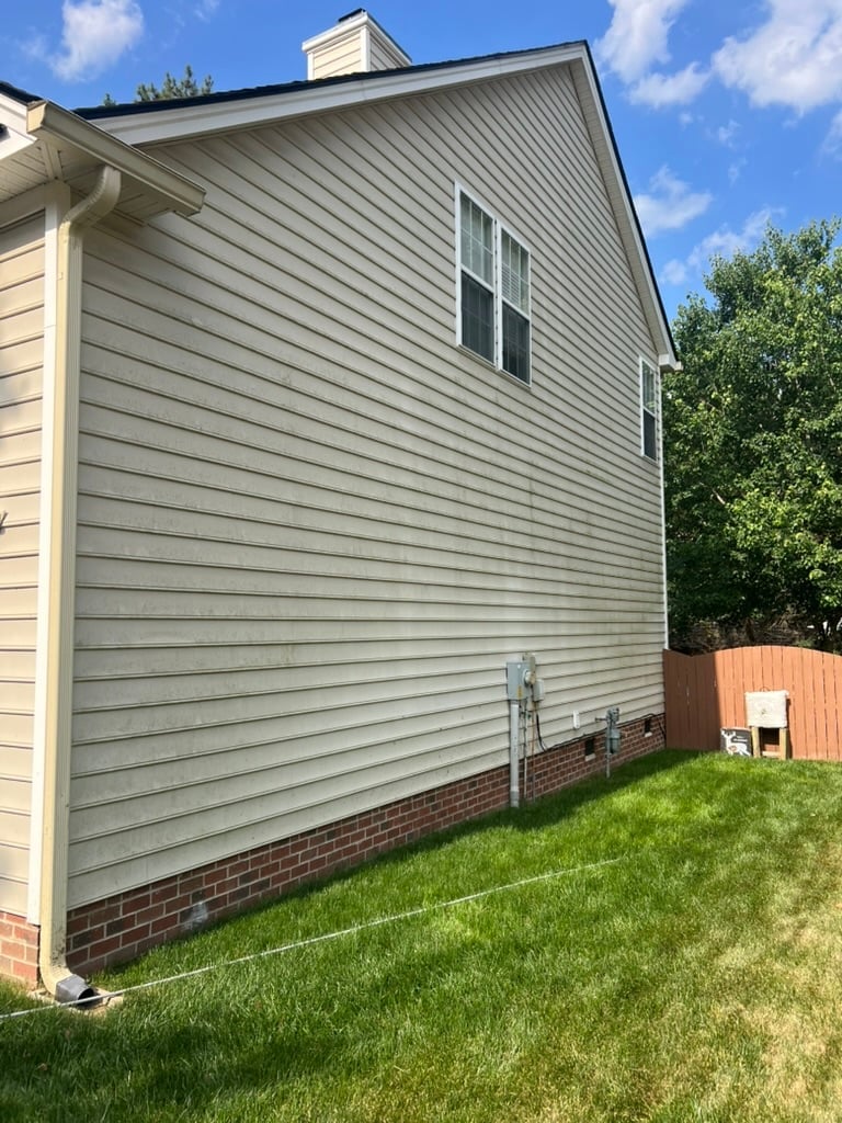 Vinyl siding dulled by mildew and grime on a Wake Forest NC home before house washing